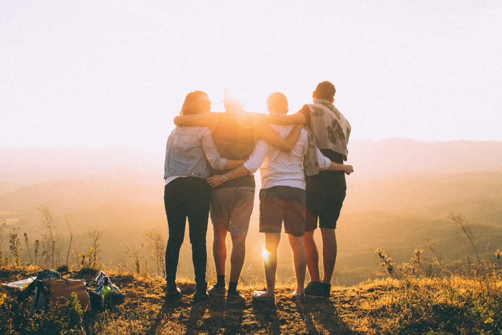 Group of friends hike at sunset